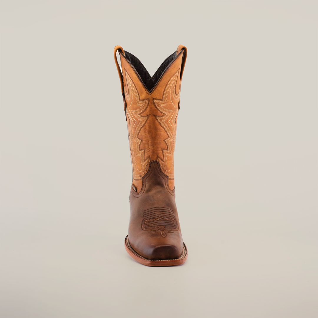 A pair of Azkar Tan - Wide Cutter Toe cowboy boots with intricate stitching is displayed against a plain white background. Made from premium cowhide leather, one boot stands upright while the other shows off its sole, emphasizing the detailed design.